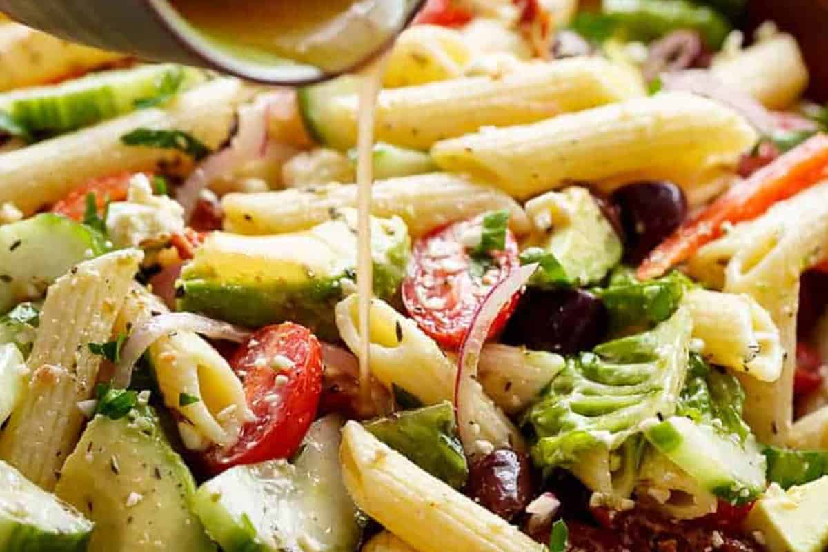 Mediterranean Pasta Salad drizzled with dressing.