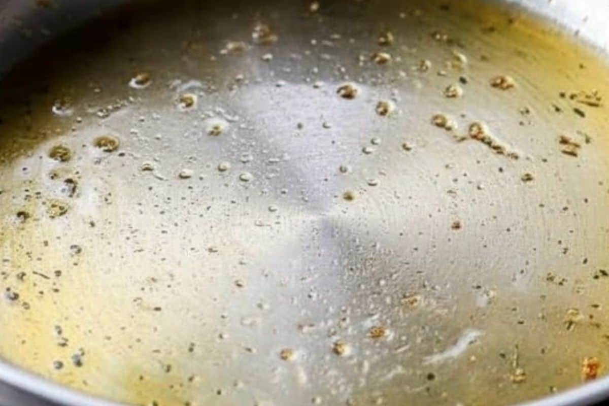 Drizzle the garlic olive oil into a large frying pan or skillet and place it over medium-high heat.