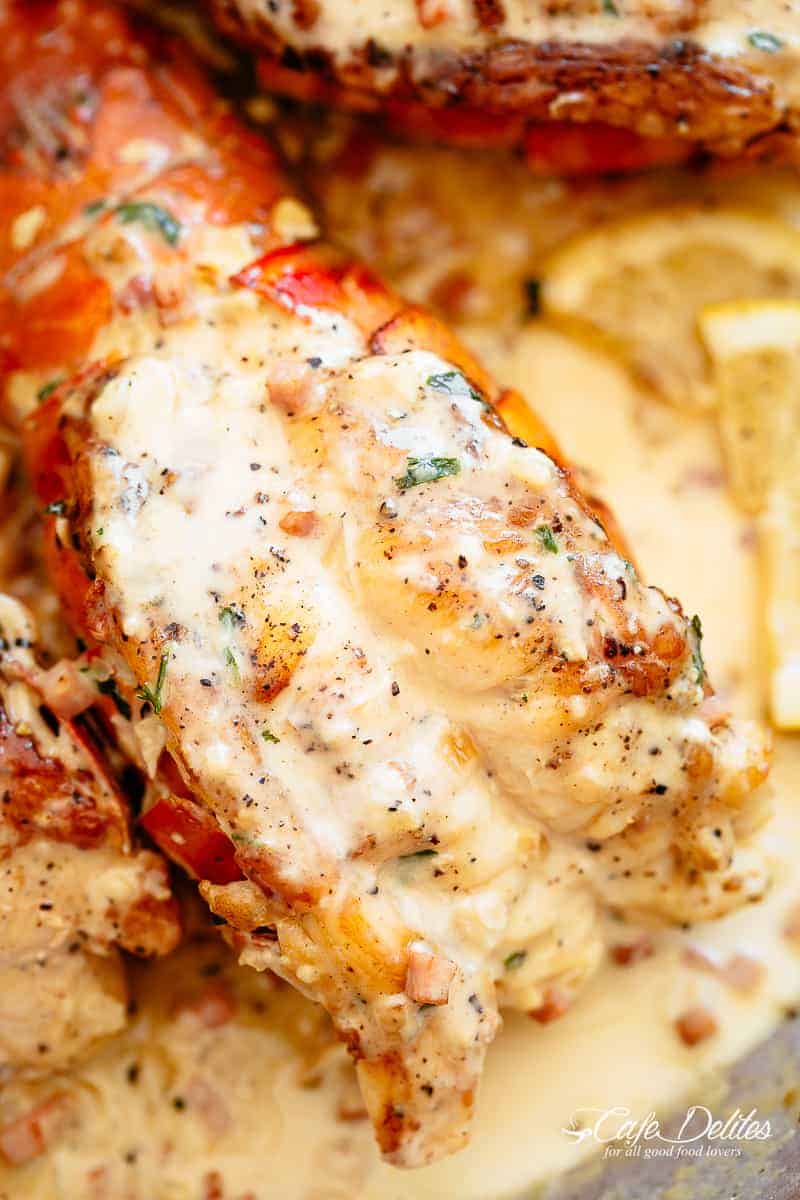 Close up image of lobster tails with a cream sauce