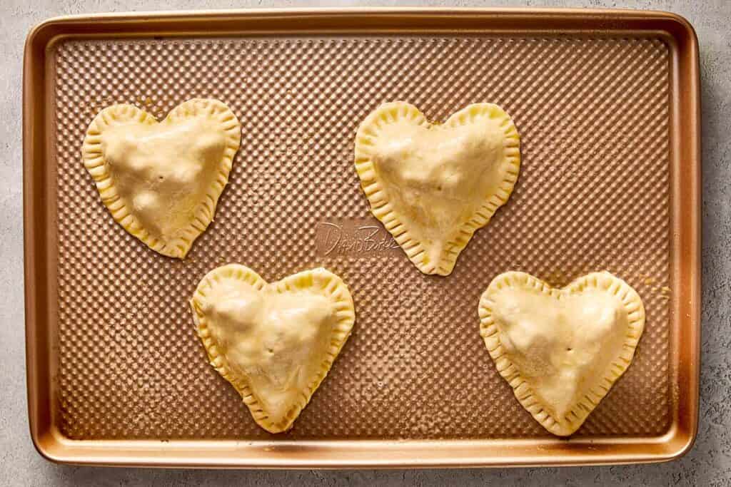 top down view of hearts on a tray ready to bake in the oven