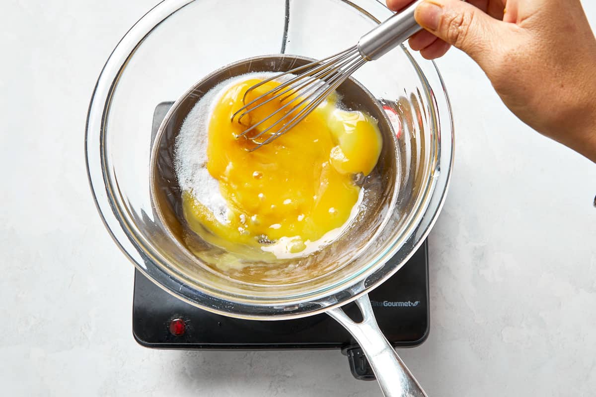 Whisking egg yolks and sugar over a double boiler for the tiramisu cups base.