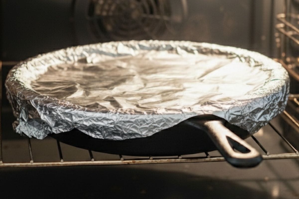Return the cooked chicken into the pan and cover tightly with a lid or foil, then transfer to the oven and bake for 40 minutes.