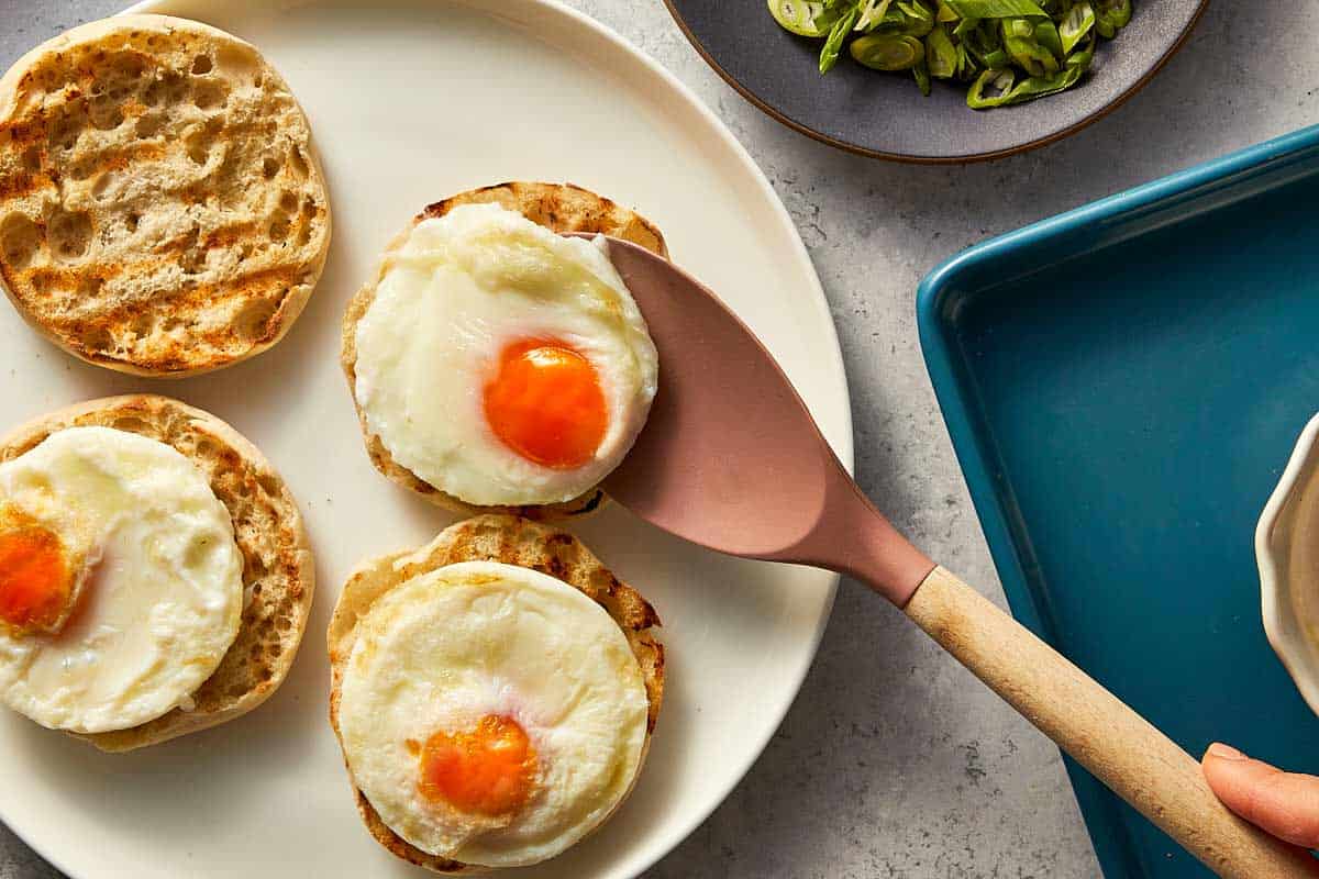 poached egg being spooned into a toast