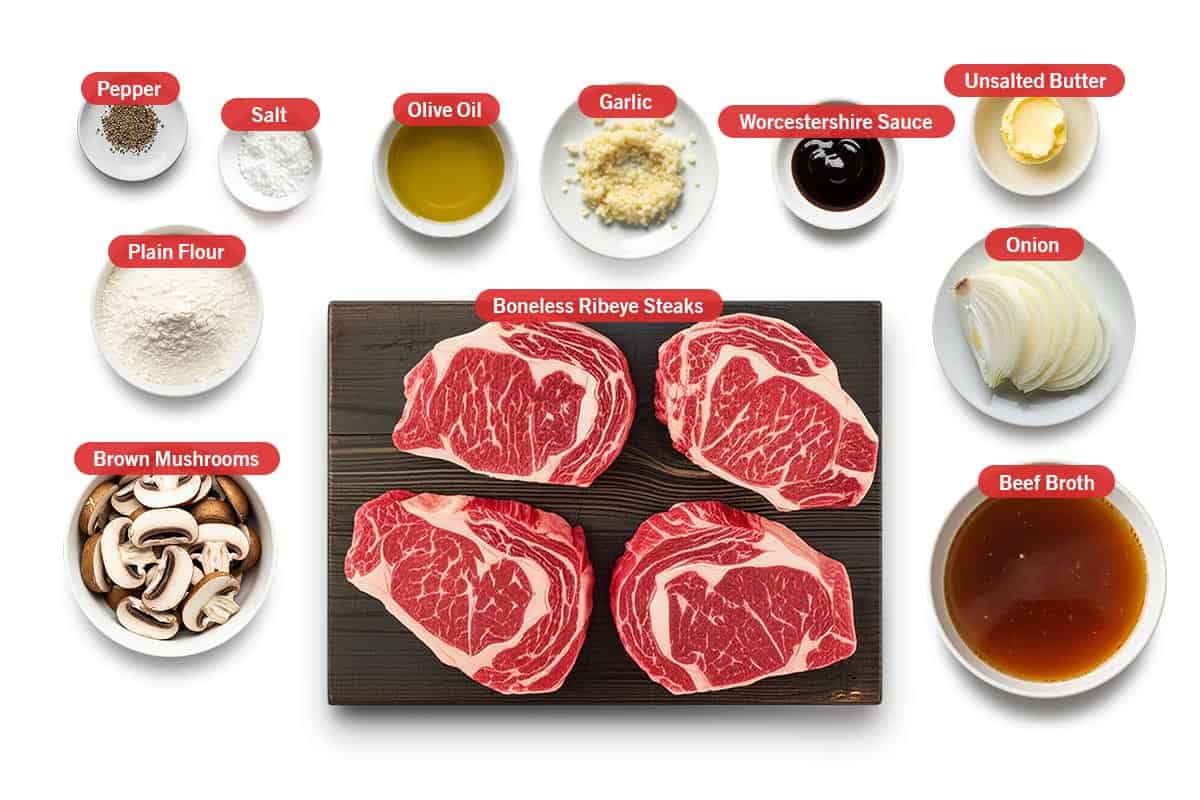 Top shot of ingredients: Pepper, salt, olive oil, garlic, Worcestershire Sauce, unsalted butter, plain flour, brown mushrooms, boneless ribeye steaks, onion, and beef broth.