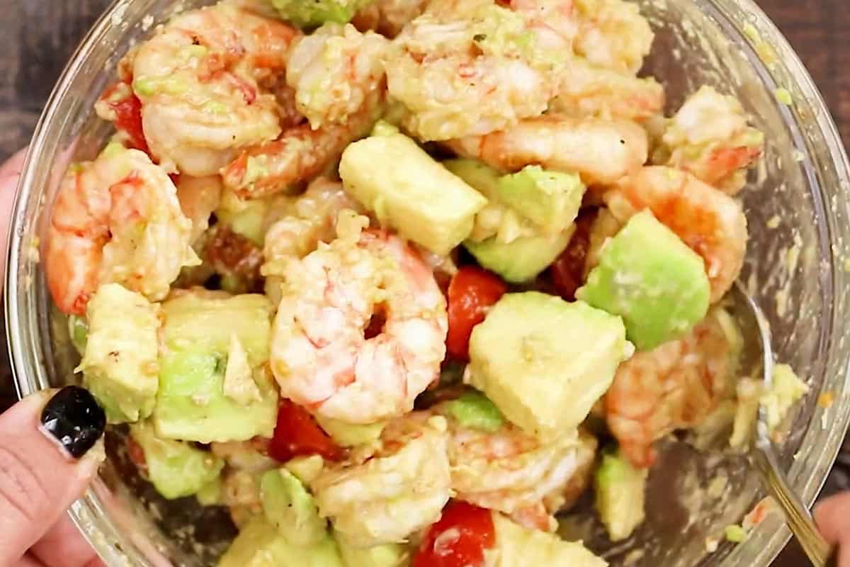 Added the cooked shrimp in the bowl of avocado salad.