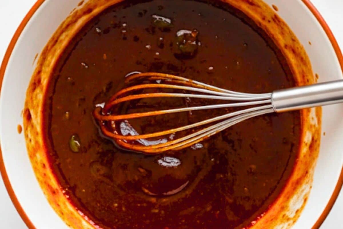 In a bowl, whisk honey, melted butter, soy sauce, oyster or hoisin, vinegar, garlic, ginger and half a scallion and combine.