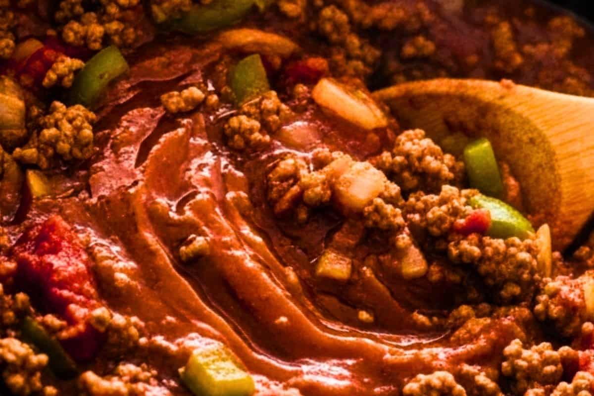 Stir in tomatoes sauce, chilies, beef bouillon, chili powder, Worcestershire sauce, cumin, paprika, cocoa, onion powder, garlic powder, salt, sugar and black pepper.