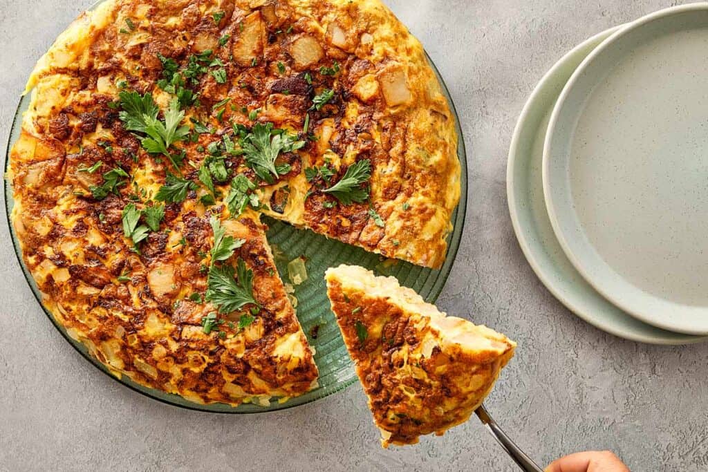 Slice of tortilla española being served