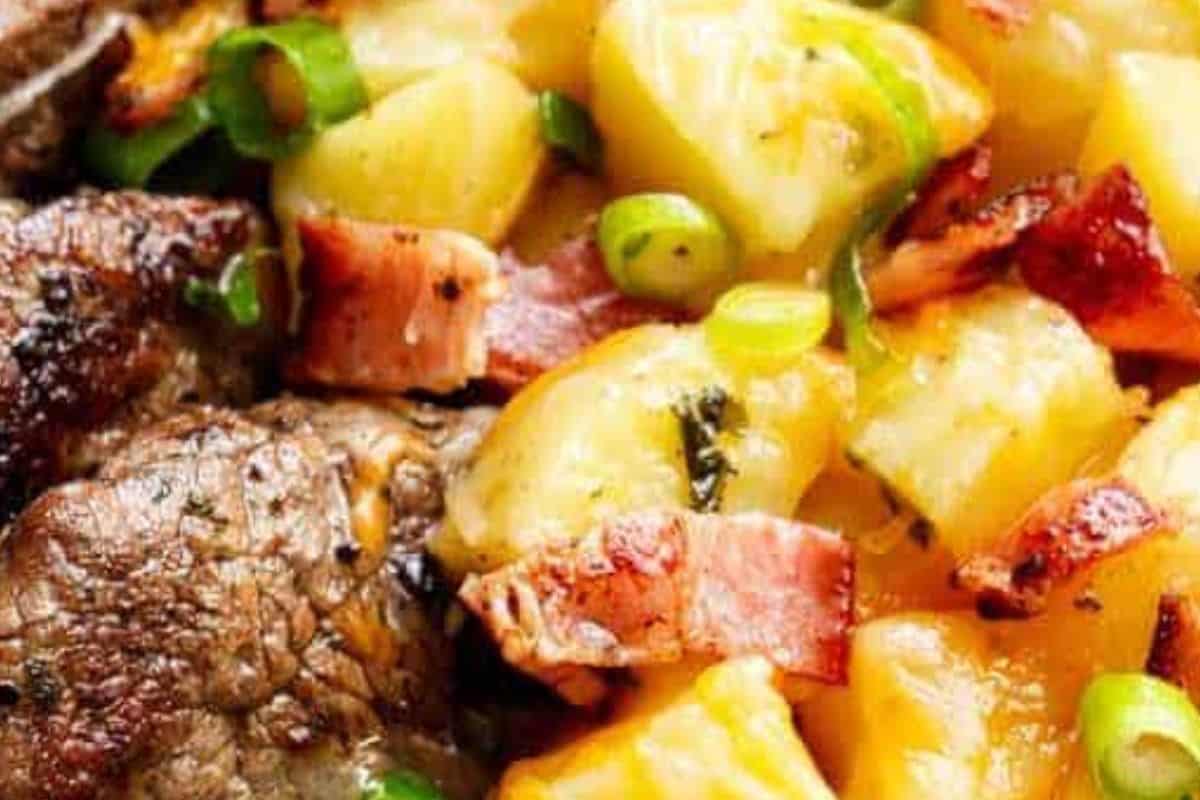 Sprinkle shredded cheese over the potatoes, tent with foil for 3 minutes to melt, then top with bacon and scallions.