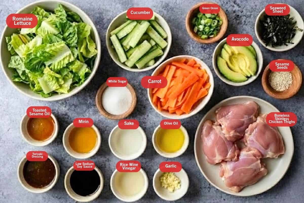 Flat lay photo of ingredient shot of romaine lettuce, cucumber, green onions, seaweed sheet, avocado, sesame seeds, boneless skinless chicken thighs, carrot, white sugar, low sodium soy sauce, mirin, sake, minced garlic, oil, sesame oil, rice wine vinegar, teriyaki dressing