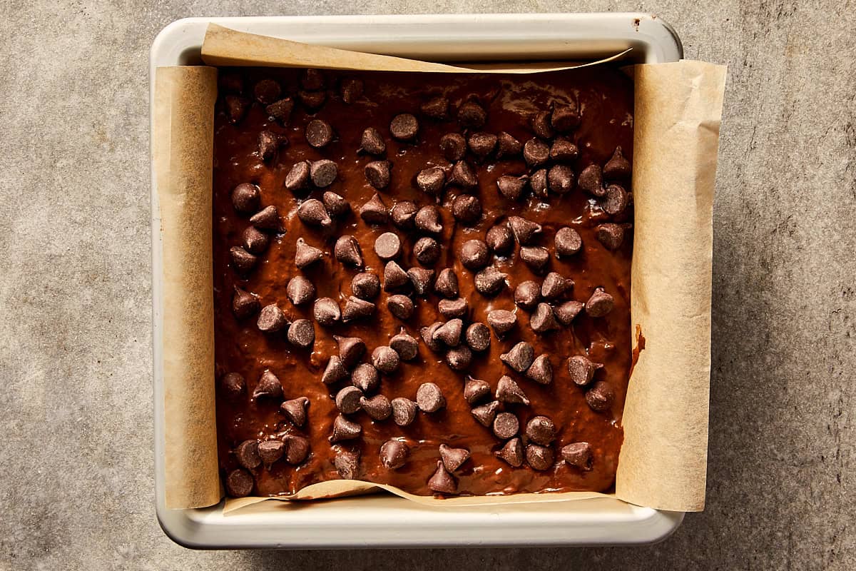 Overview top of mix for sweet potato brownies ready to go to the oven, sprinkled with diet chocolate chips at the top.