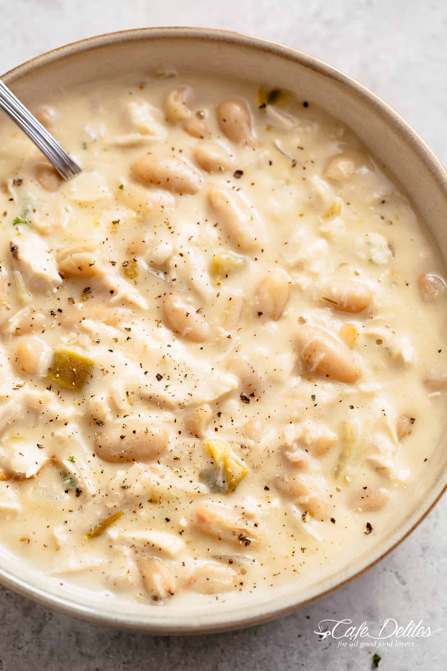 White Turkey Chili with spoon in a bowl
