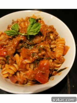 Close-up of a serving of delicious ground turkey spaghetti sauce over pasta.