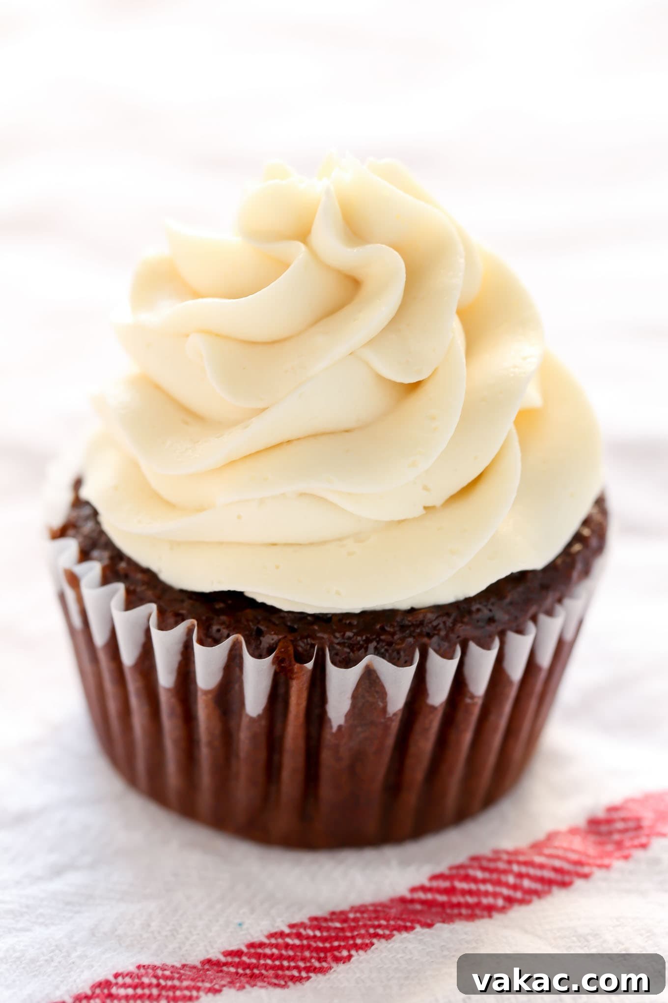 Elevate Your Cupcakes with Perfect Frosting 8 A perfectly piped cupcake with a tall, elegant buttercream swirl created using a piping bag