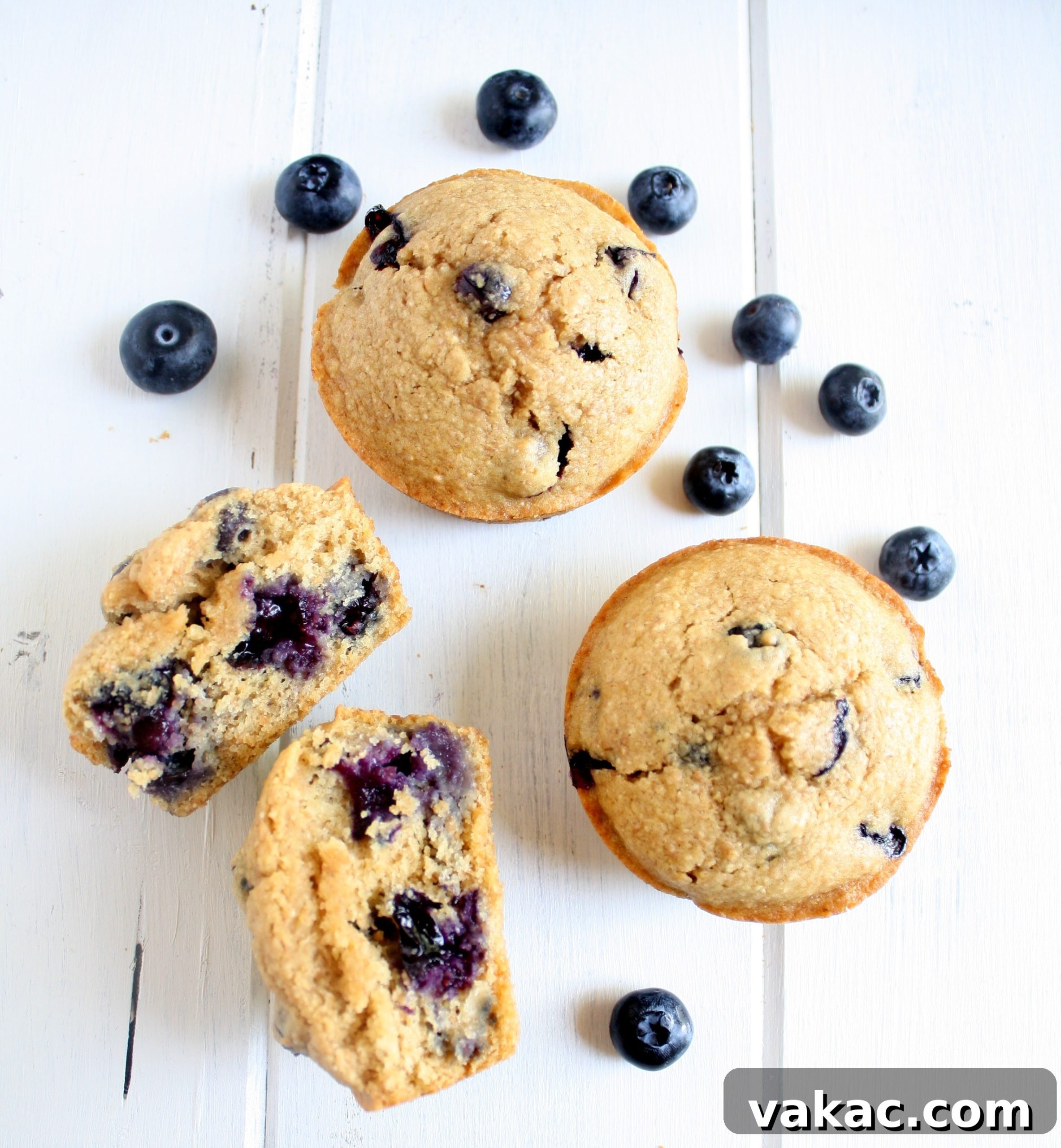 Wholesome Blueberry Morning Muffins 4 Overhead view of three healthy blueberry muffins. One muffin has been torn in half.