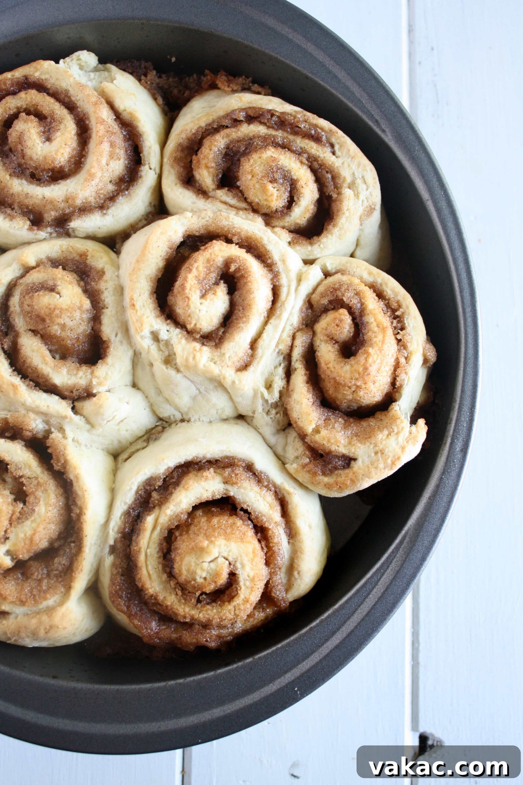 Cinnamon Rolls in a Snap 3 Unfrosted no yeast cinnamon rolls in a round baking pan.