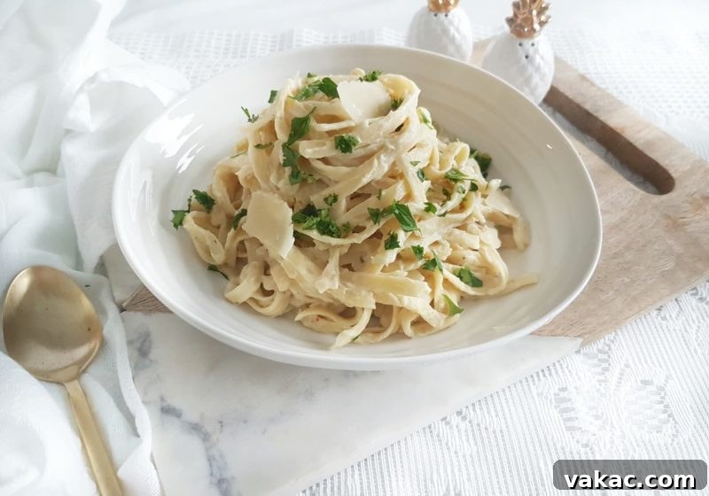 Choosing Your Perfect Pasta: A Noodle Showdown 6 A delectable plate of Cauliflower Fettuccini Alfredo, showing creamy sauce coating pasta with a garnish of fresh herbs.