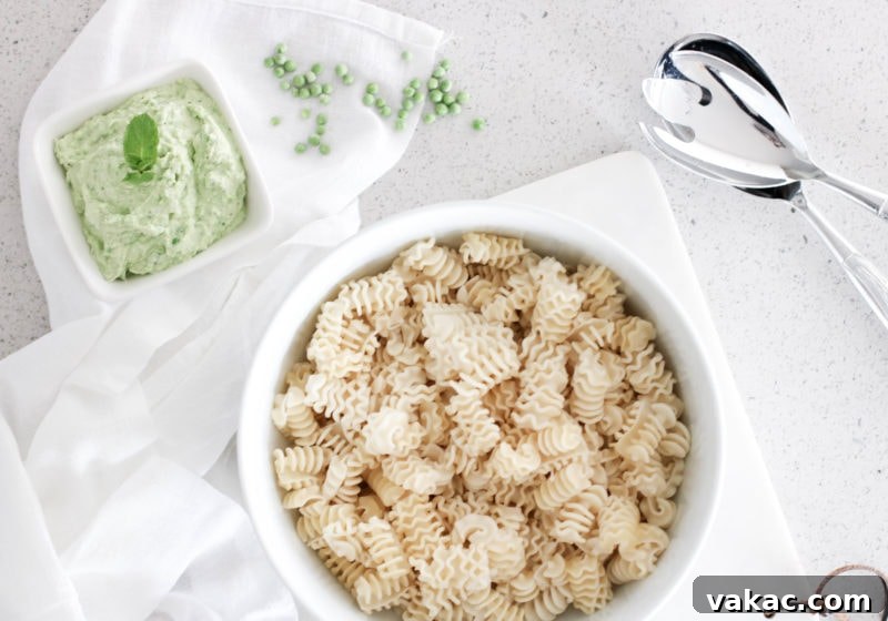 Choosing Your Perfect Pasta: A Noodle Showdown 7 A beautifully plated dish of Sourdough Pasta with Ricotta, Mint, and Spring Pea Pesto, garnished with fresh herbs and cheese.