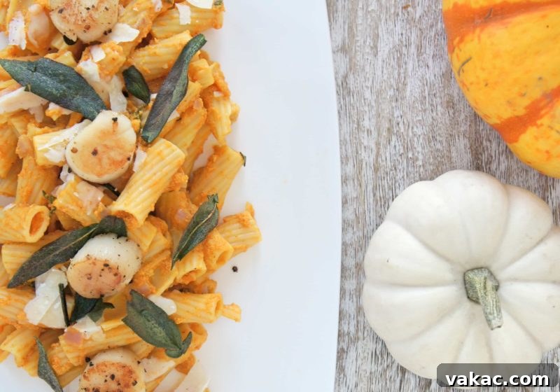 Choosing Your Perfect Pasta: A Noodle Showdown 8 A gourmet dish of Creamy Pumpkin Sage Pasta with perfectly Seared Scallops, garnished with fresh sage leaves.