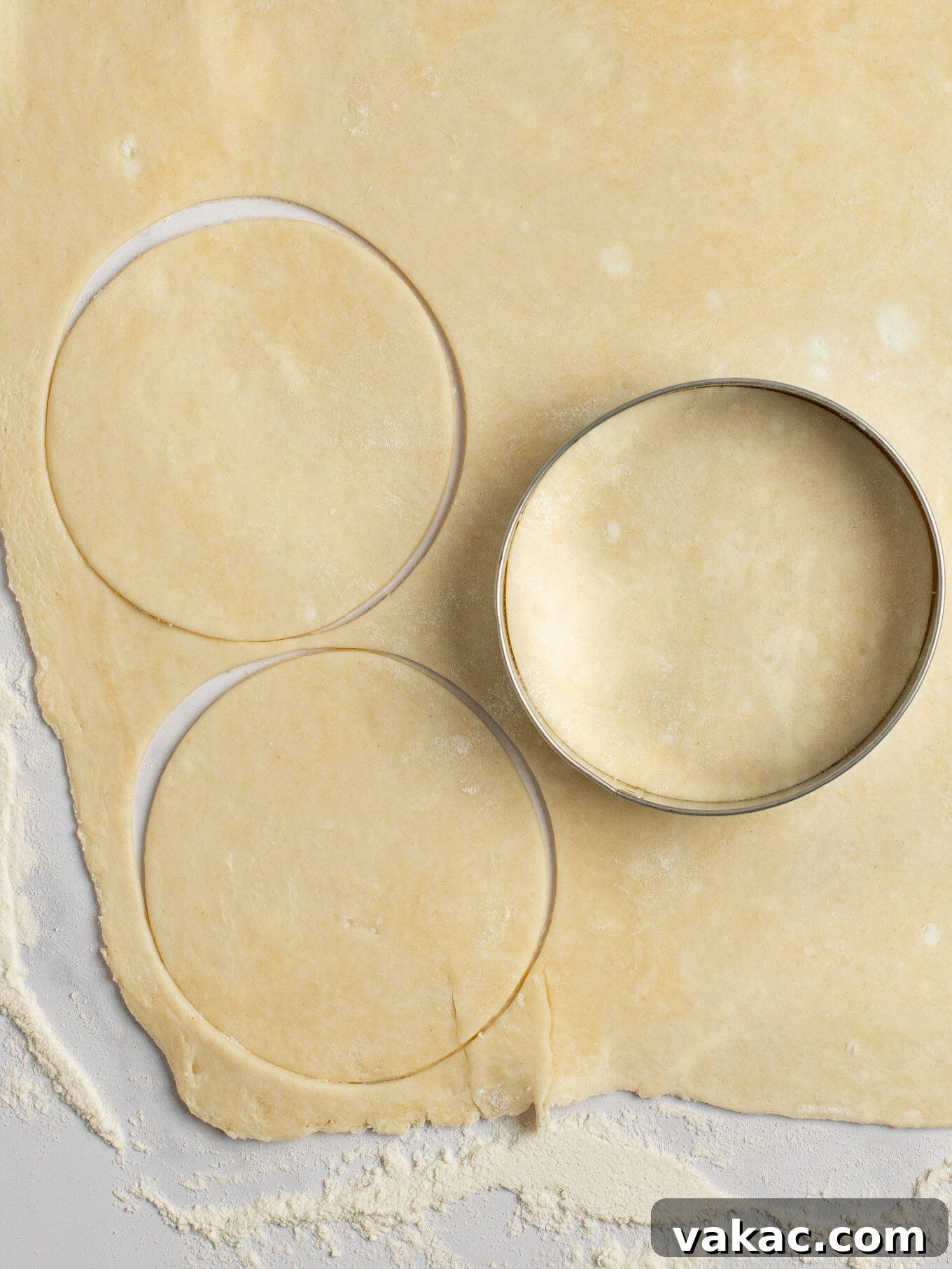 Sweet Apple Pie Bites 4 An overhead view of pie crust being cut into 3.5-inch circles.