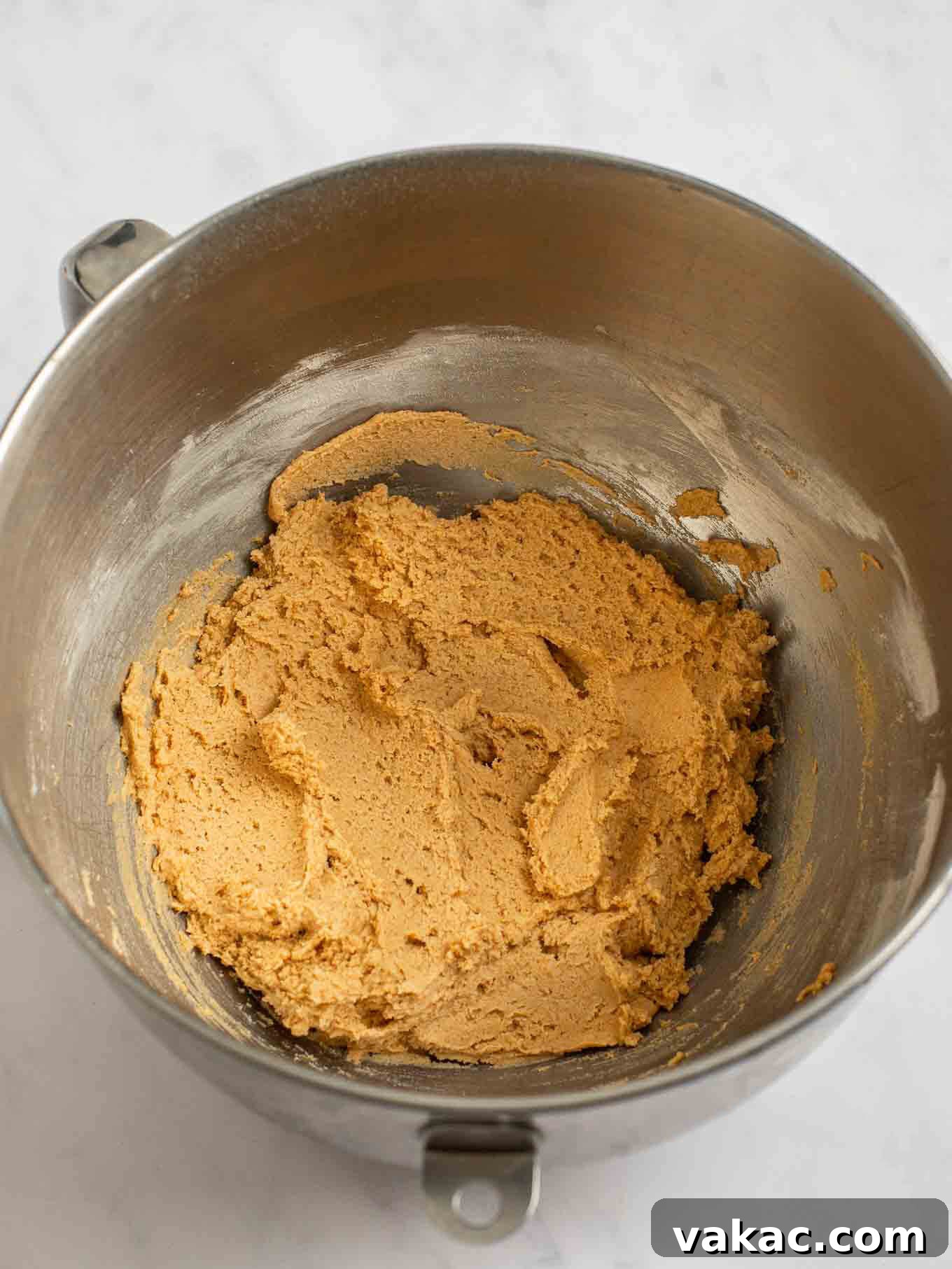 Spiced Pumpkin Snickerdoodles 7 The pumpkin snickerdoodle cookie dough is perfectly mixed and ready for chilling, showcasing a beautiful orange hue.