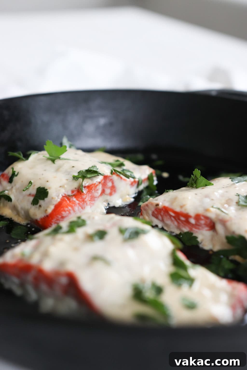 Effortless Miso-Yogurt Salmon Roast 2 A beautifully presented serving of Miso-Yogurt Oven-Baked Salmon, showing the rich, golden marinade and tender, flaky texture of the fish. It's accompanied by fresh green vegetables, emphasizing a healthy, balanced, and visually appealing meal.