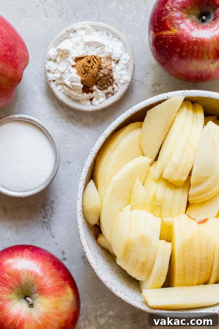 Apple crisp ingredients laid out on a rustic gray surface.