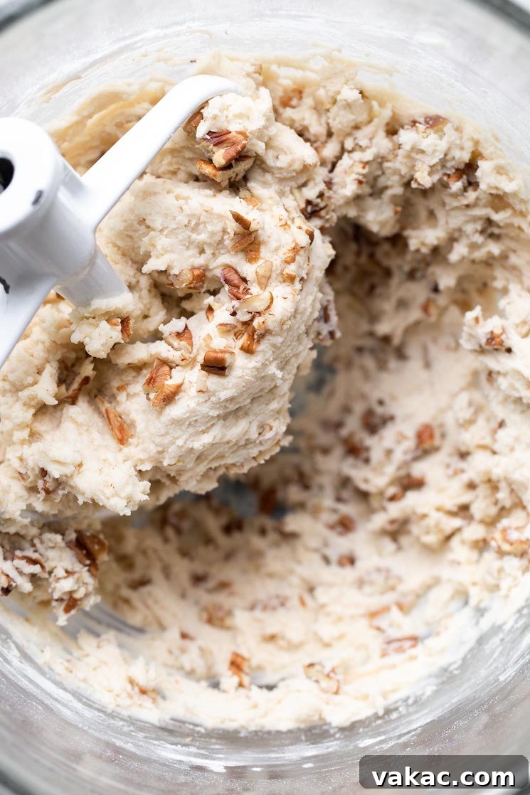 A glass mixing bowl filled with cookie dough.