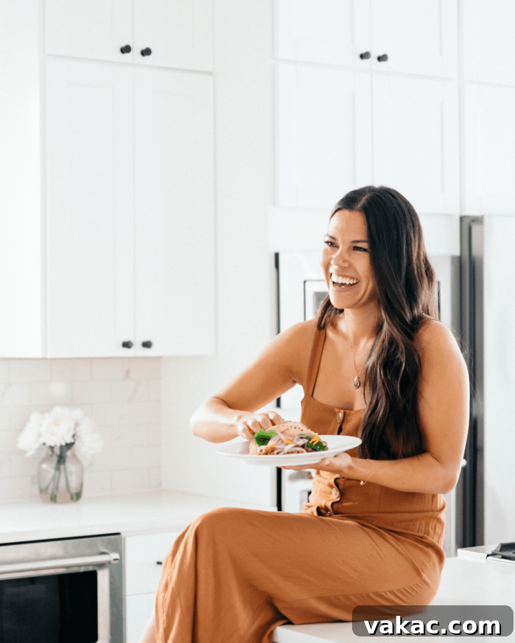 The Make Food Feel Good Program Explained 2 A woman smiling confidently while holding a healthy meal