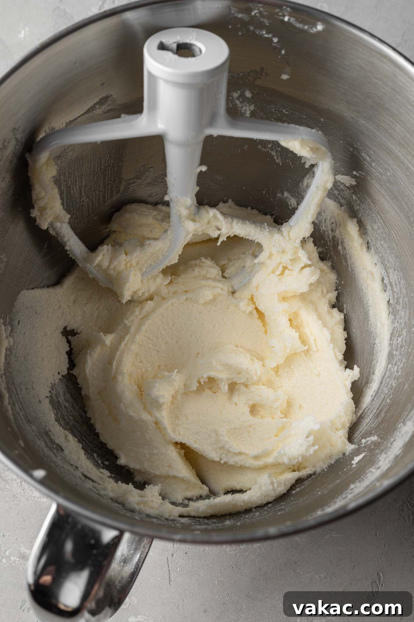An overhead view of softened butter and granulated sugar beaten together until they are light in color and fluffy in texture.