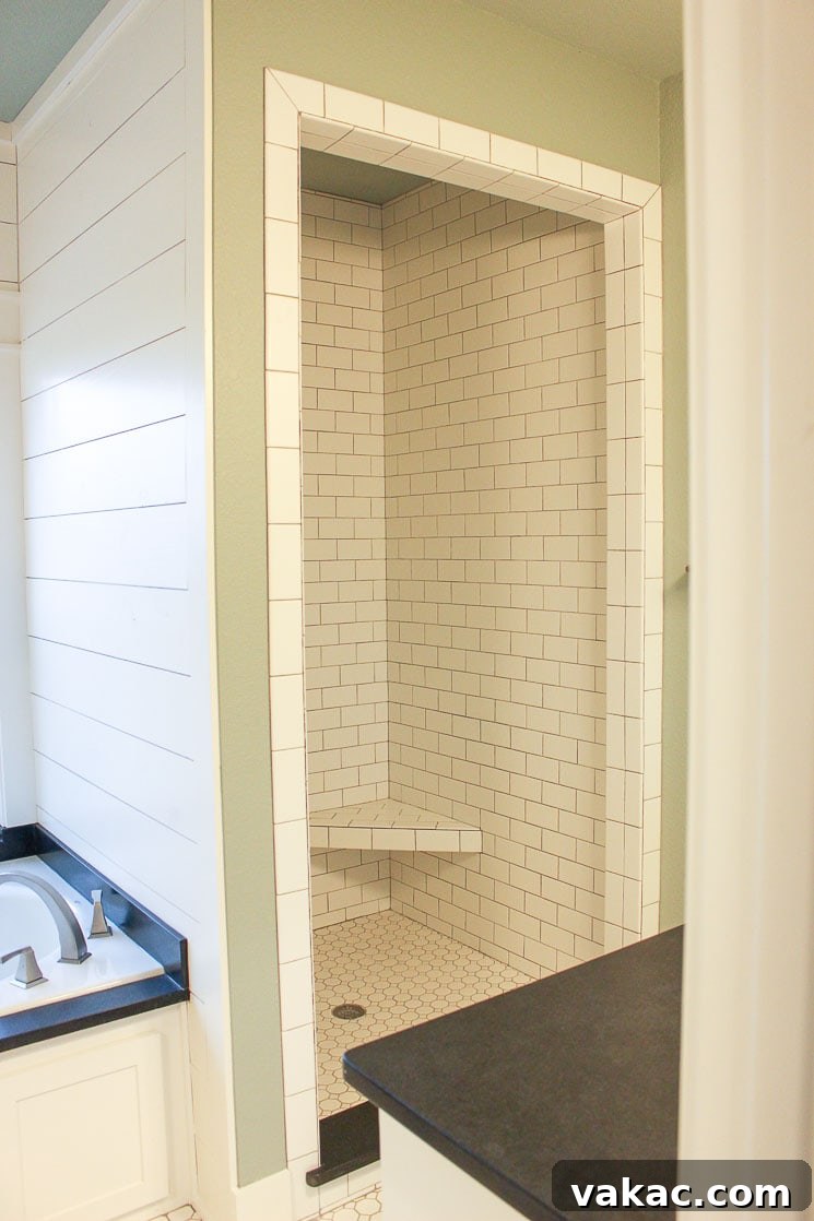 Our New Home Tour and Life Lately 13 A luxurious bathroom featuring a whirlpool tub surrounded by elegant shiplap paneling and pristine white subway tiles, creating a relaxing sanctuary.