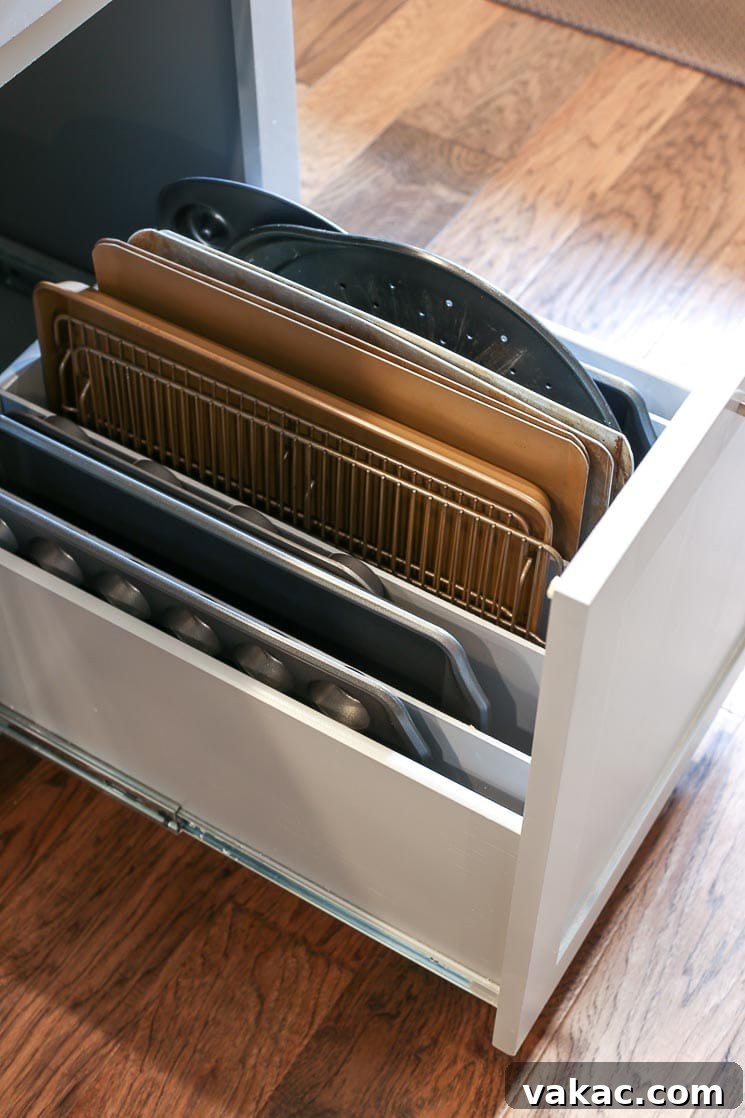 Our New Home Tour and Life Lately 5 A custom pull-out drawer with vertical dividers, perfectly organizing baking pans, cookie sheets, and cutting boards right next to the ovens.