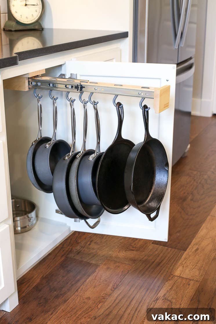 Our New Home Tour and Life Lately 6 A clever pull-out pot and pan organizer rack discreetly hidden inside a kitchen cabinet, offering easy access to cookware near the stovetop.