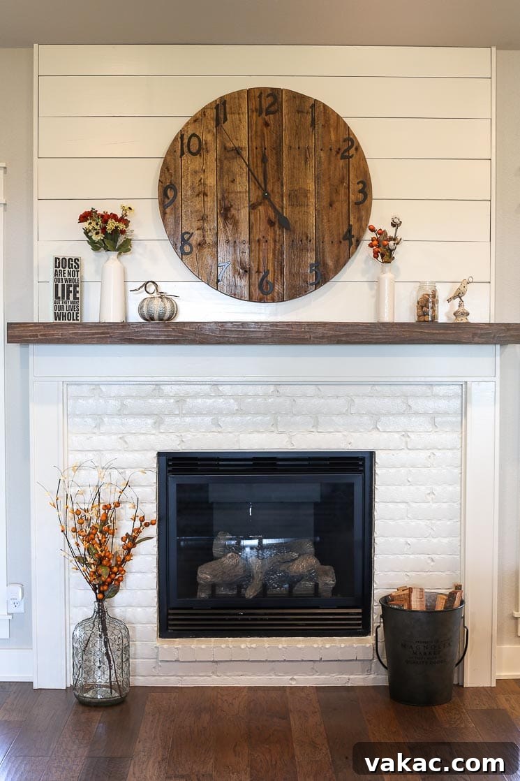 Our New Home Tour and Life Lately 8 A beautifully designed living room with a white painted brick fireplace, shiplap detailing above the mantle, and a custom wooden clock.
