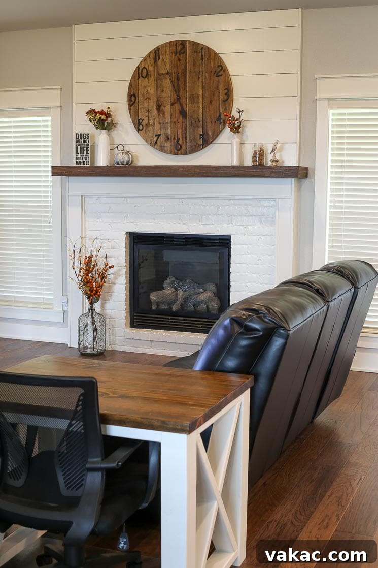 Our New Home Tour and Life Lately 9 A spacious living room featuring a white fireplace, comfortable seating, and a view of the adjacent dining area, awaiting final decor touches.