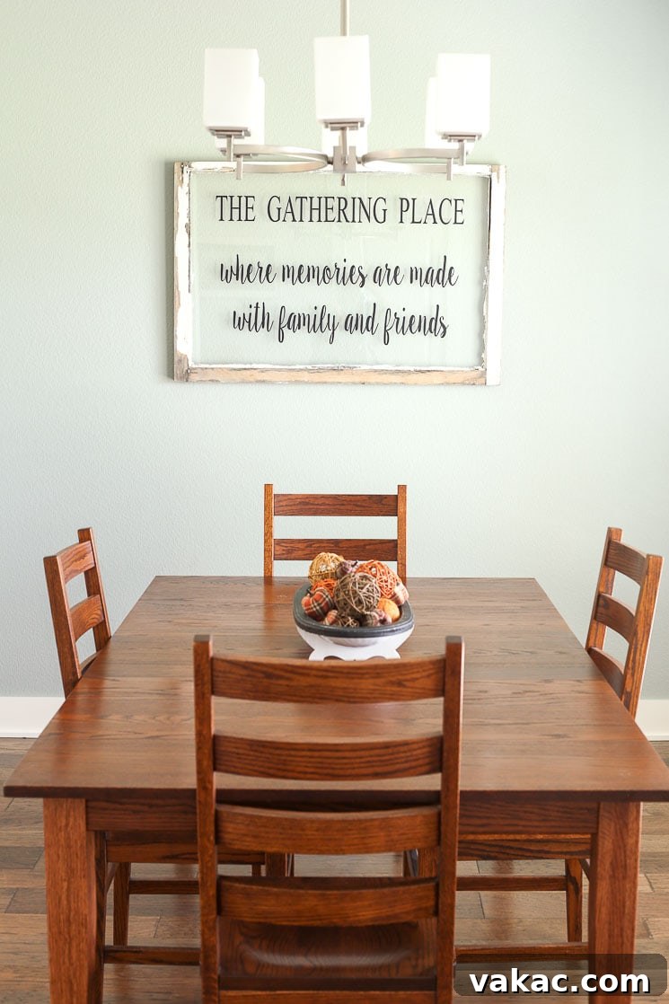 Our New Home Tour and Life Lately 10 A elegant dining room with a large wooden table and chairs, illuminated by natural light.