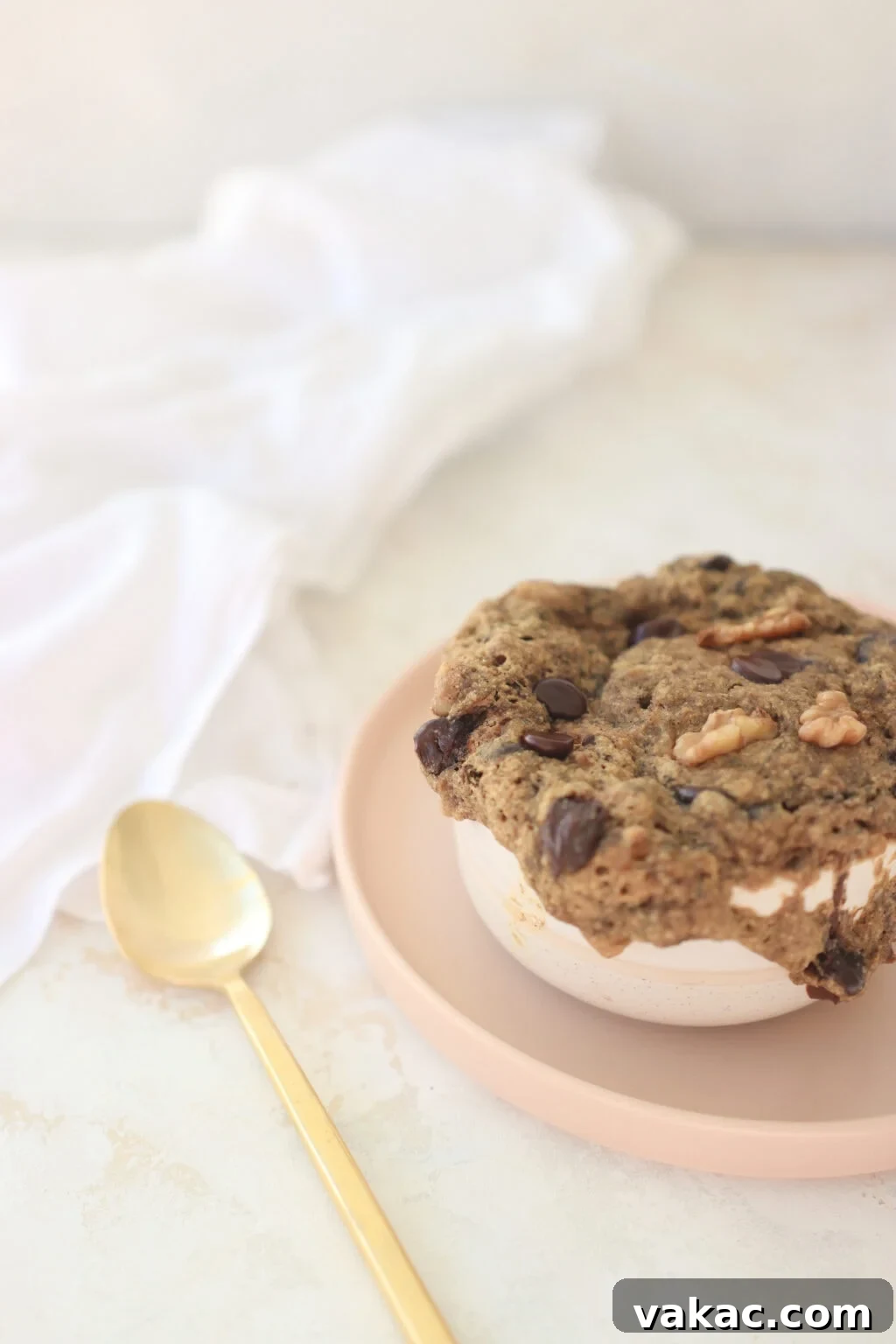 One-Minute Banana Bread Dream 2 A perfectly baked banana bread mug cake, golden brown with visible chocolate chips, served in a cozy mug.