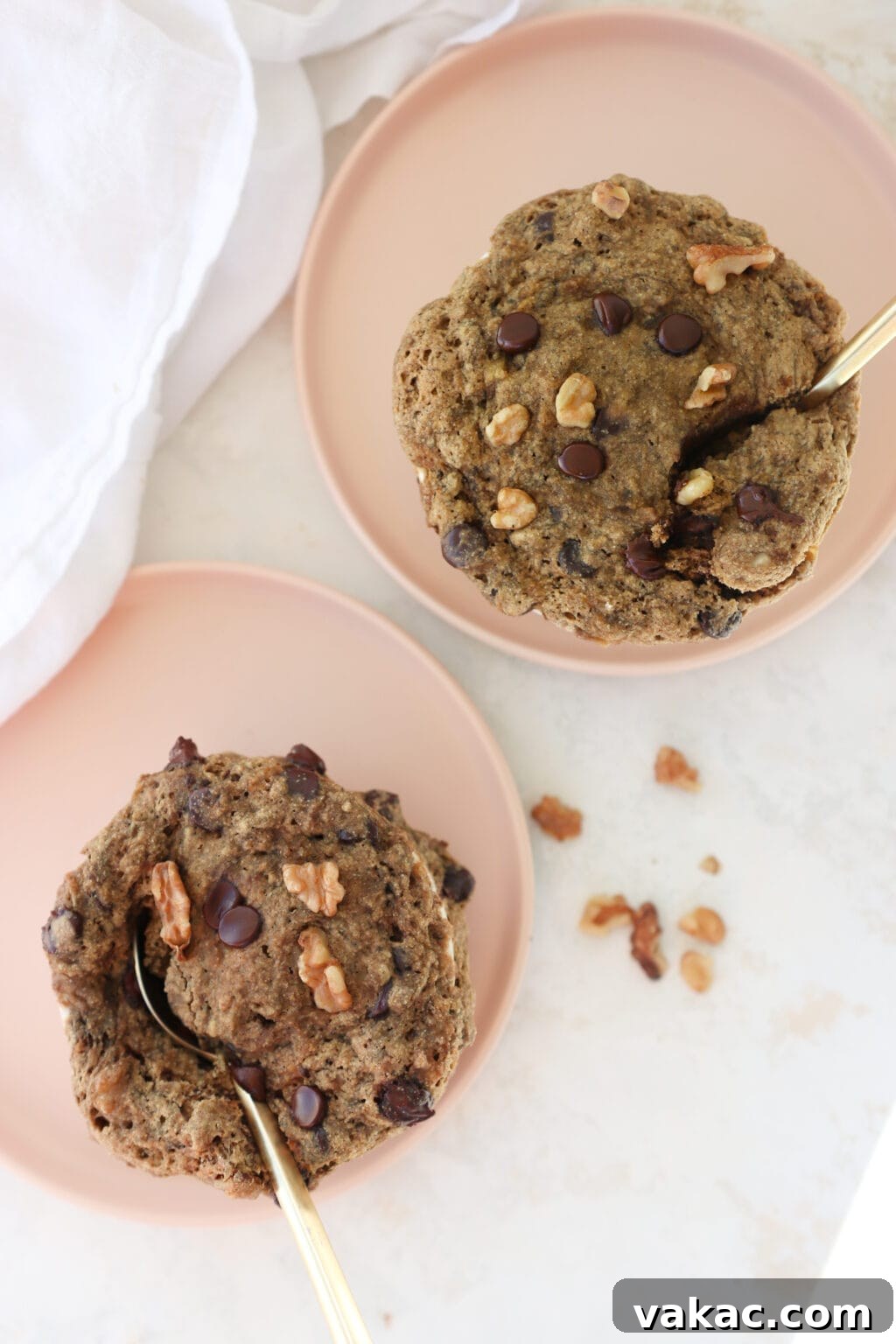 One-Minute Banana Bread Dream 5 A close-up of a banana bread mug cake with a spoonful taken out, revealing its moist interior, topped with extra chocolate chips and walnuts.