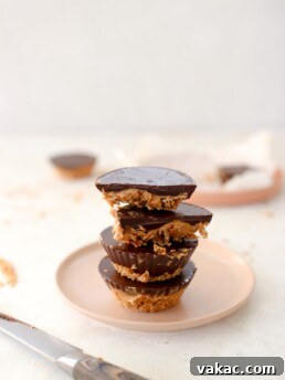 A delicious homemade peanut butter oat cup with a bite taken out, showing the layers.