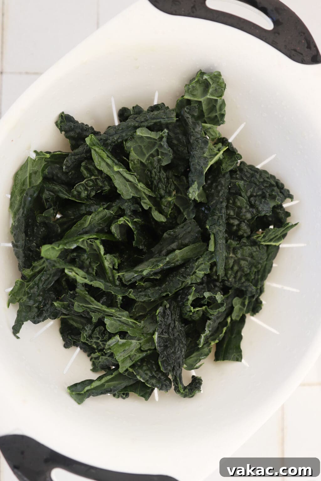 Quick Comfort: 4-Ingredient Warm Kale & Toasted Coconut Salad 4 Preheating oven and preparing kale by washing and removing tough stems.