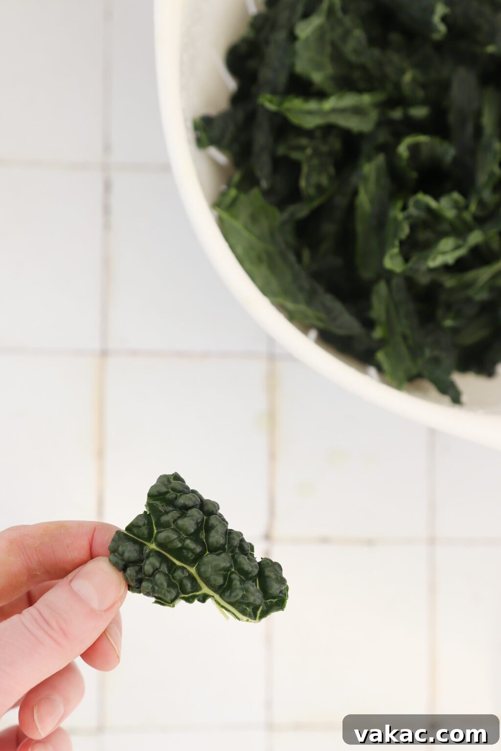 Quick Comfort: 4-Ingredient Warm Kale & Toasted Coconut Salad 5 Tearing washed kale leaves into bite-sized pieces for baking.