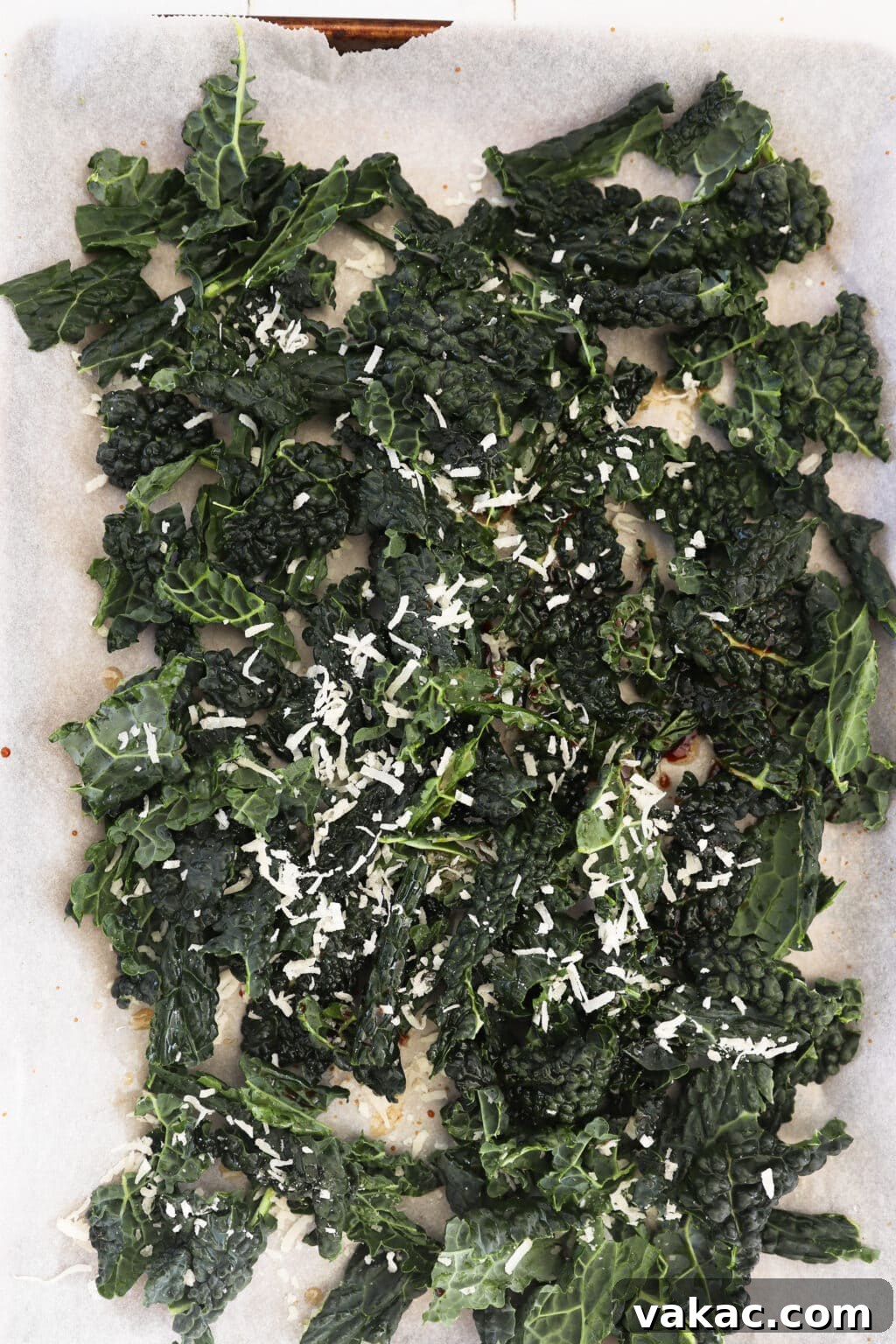 Quick Comfort: 4-Ingredient Warm Kale & Toasted Coconut Salad 8 Tossing kale with shredded coconut, salt, and pepper to evenly coat.