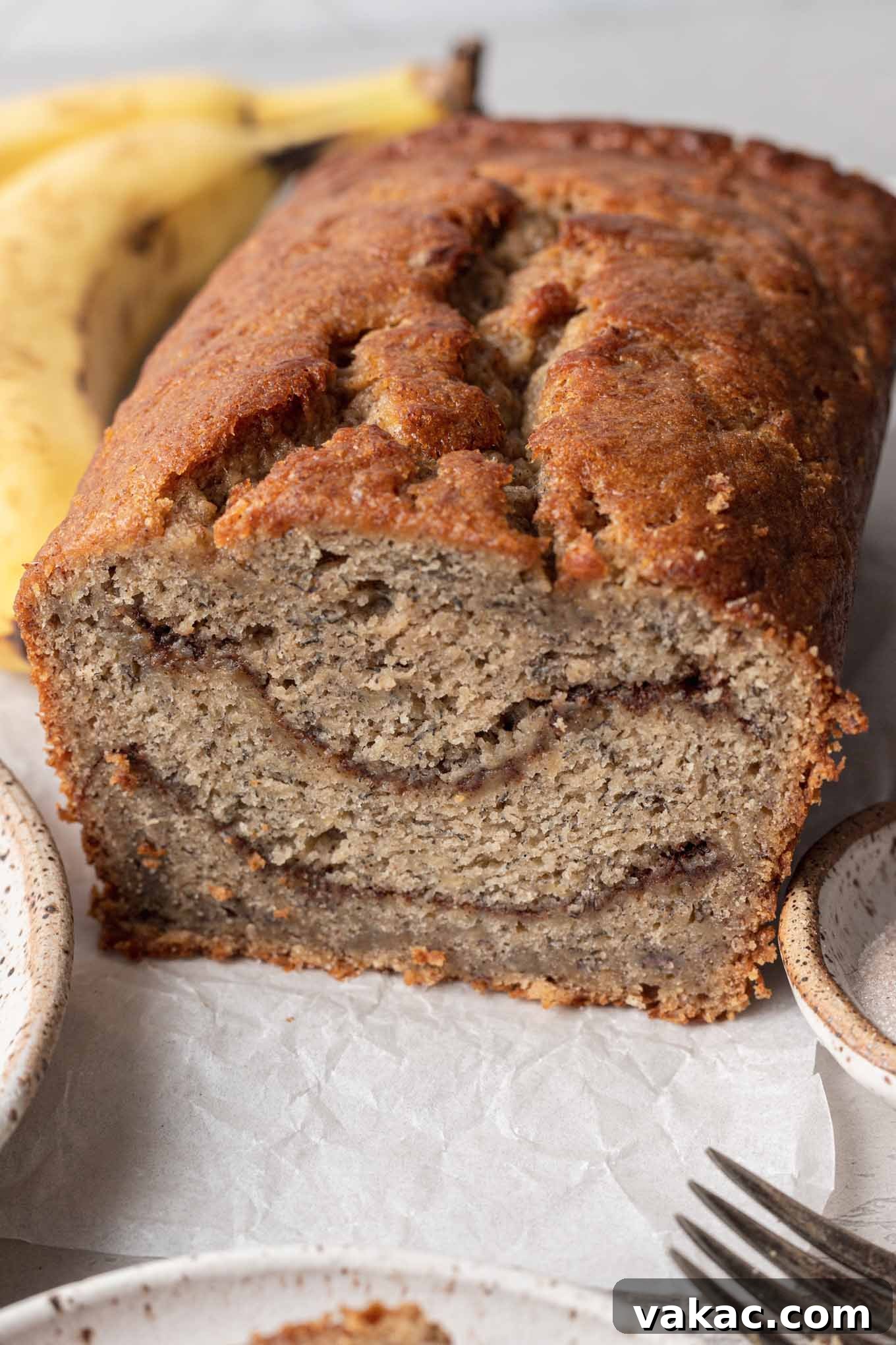 Marbled Cinnamon Banana Loaf 8 A freshly baked loaf of banana bread with visible cinnamon swirls on the top, perfectly golden brown.