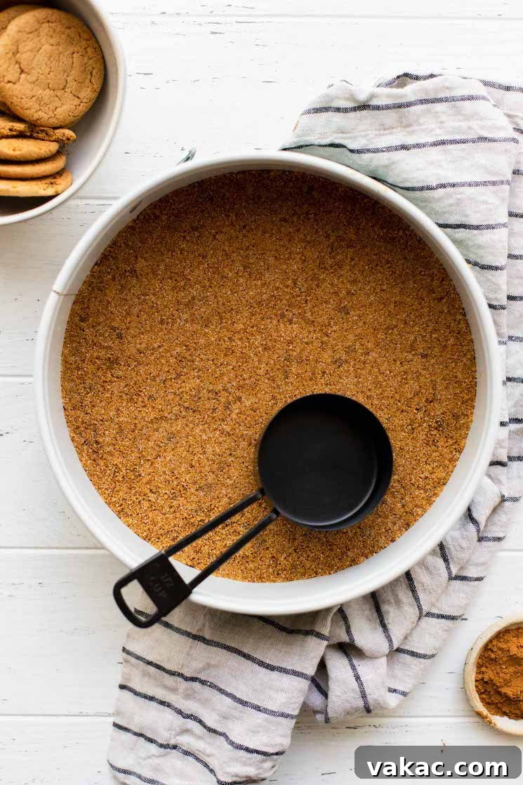 Spiced Pumpkin Indulgence 4 A springform pan with the gingersnap crust pressed down, ready for baking.