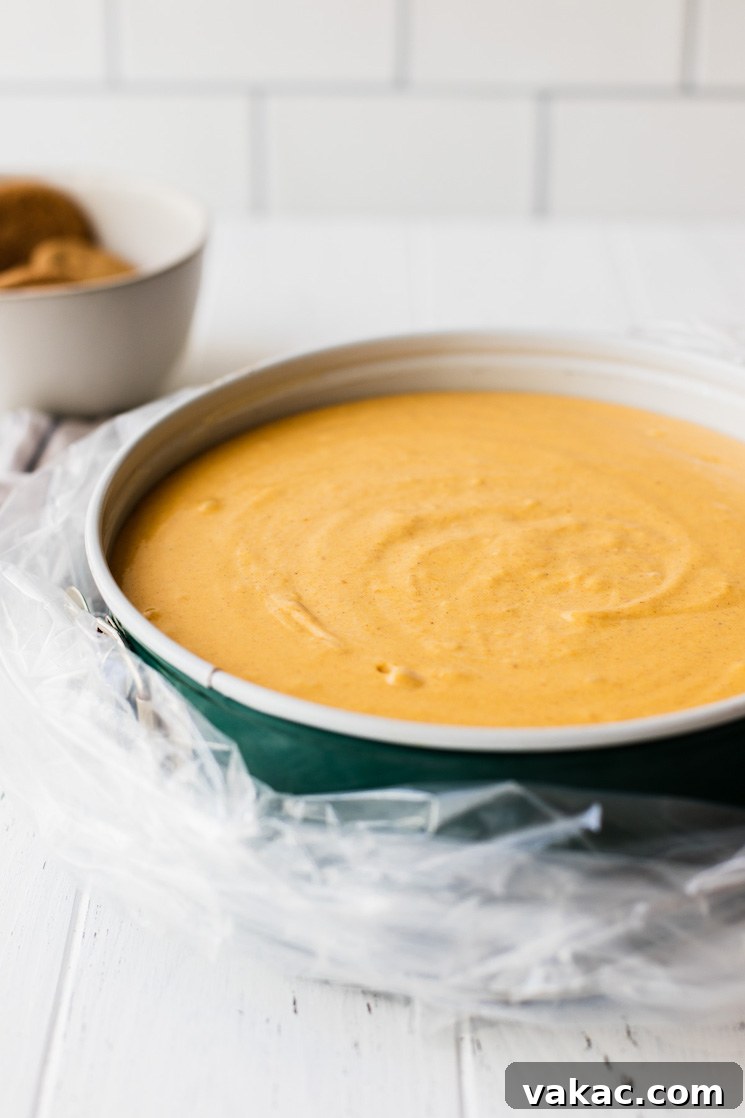 Spiced Pumpkin Indulgence 5 A spring form pan filled with cheesecake filling wrapped in an oven bag to bake in a water bath, showing preparation for baking.