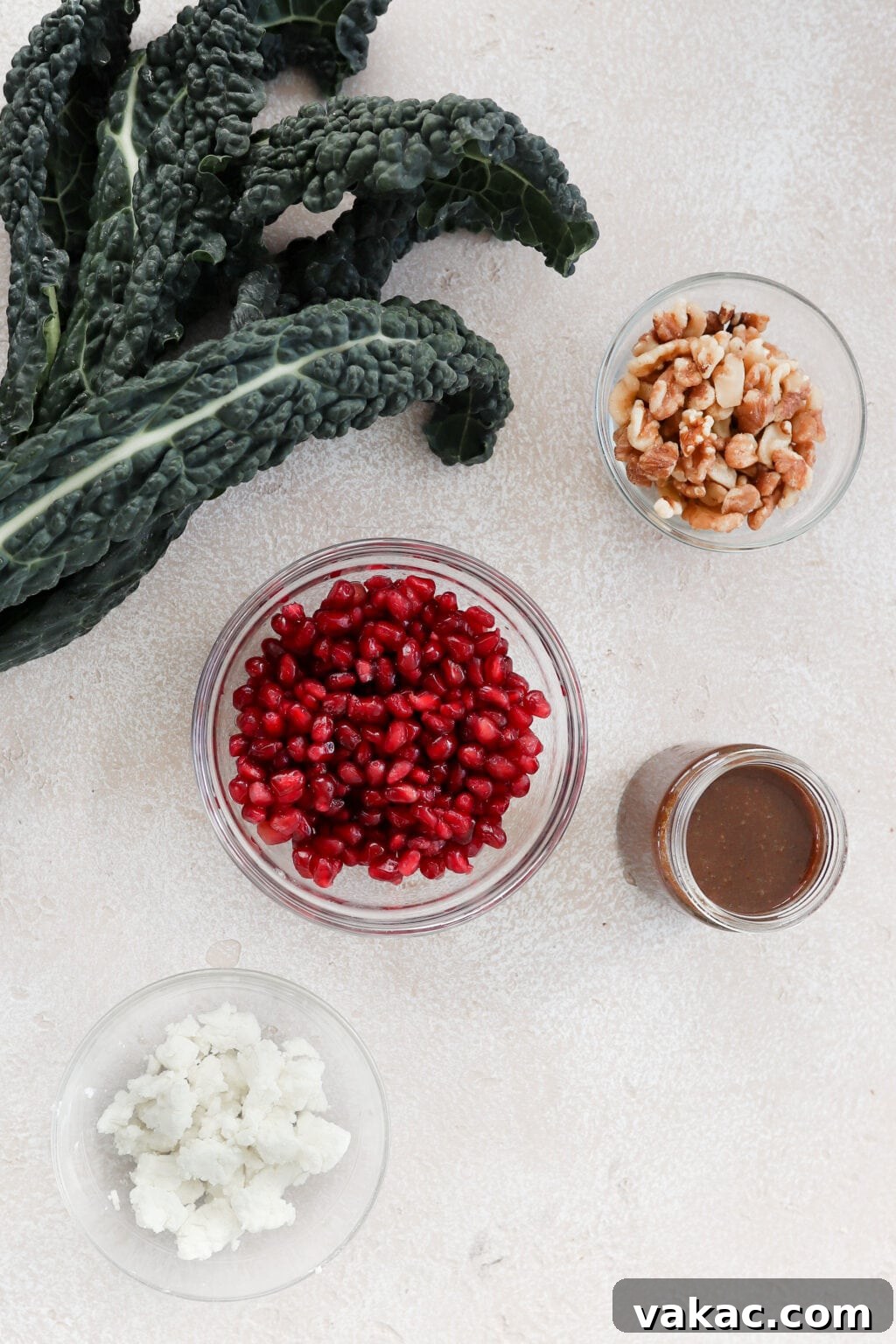Close-up shot of a vibrant Kale Pomegranate Salad with goat cheese and walnuts, showcasing the fresh ingredients.