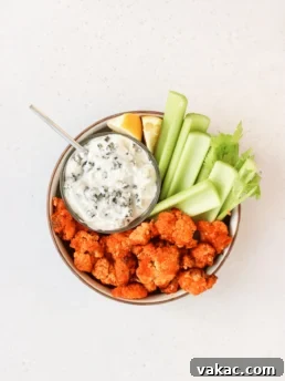Air fryer crispy buffalo cauliflower bites with dipping sauce.