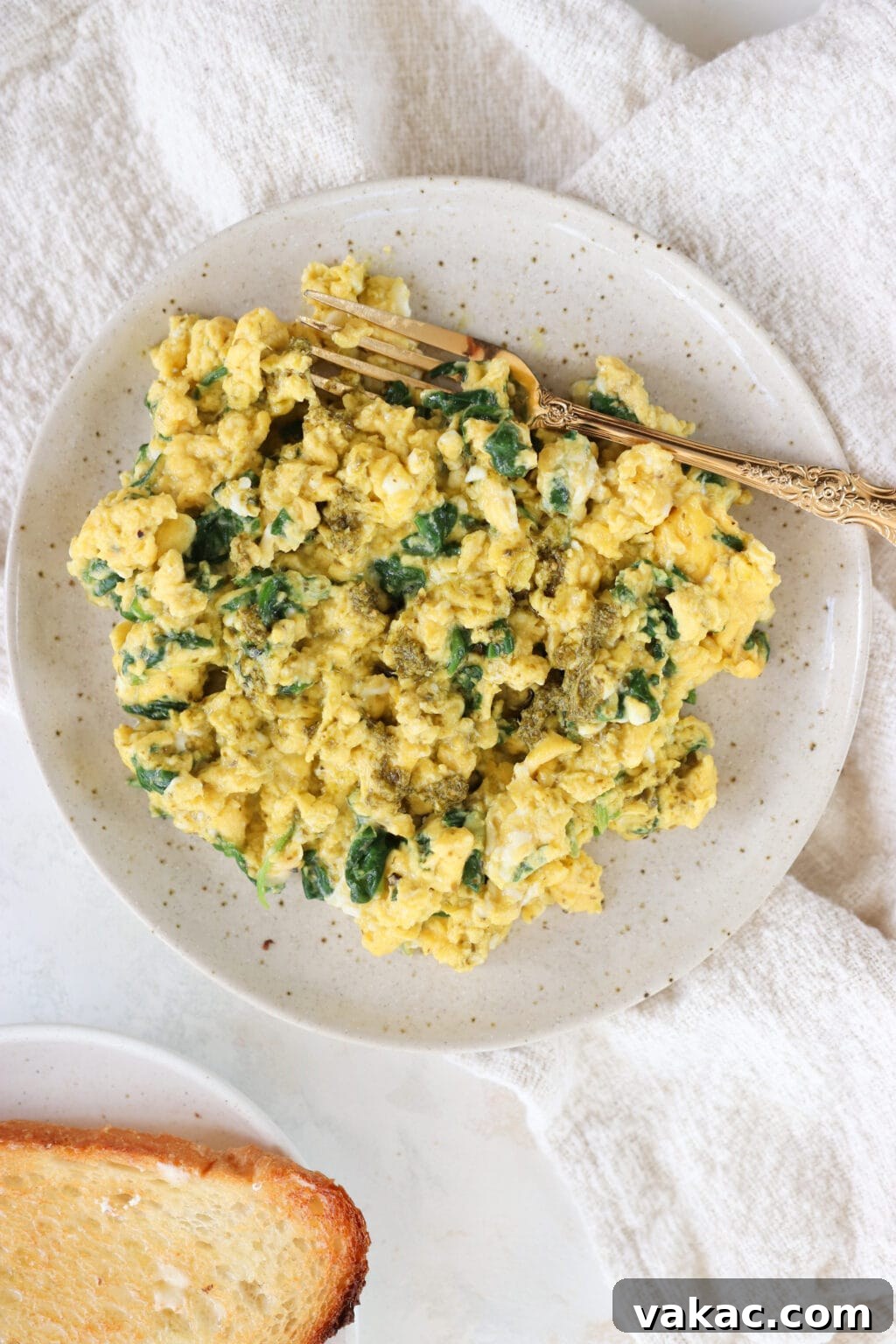 Dreamy 10-Minute Cottage Cheese Scramble 9 A full plate of vibrant green scrambled eggs with spinach, perfectly cooked and ready to be served, showcasing their light and fluffy texture.
