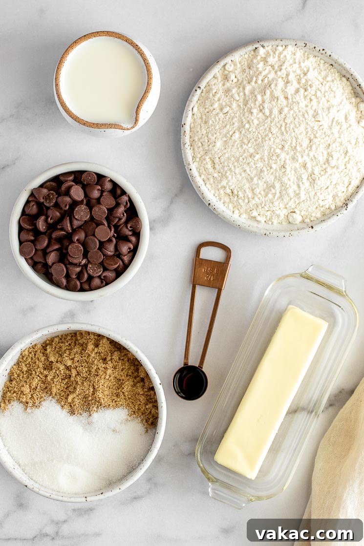 No-Bake Cookie Dough Delights 3 The array of fresh ingredients for edible cookie dough displayed neatly on a elegant marble surface, ready for preparation.
