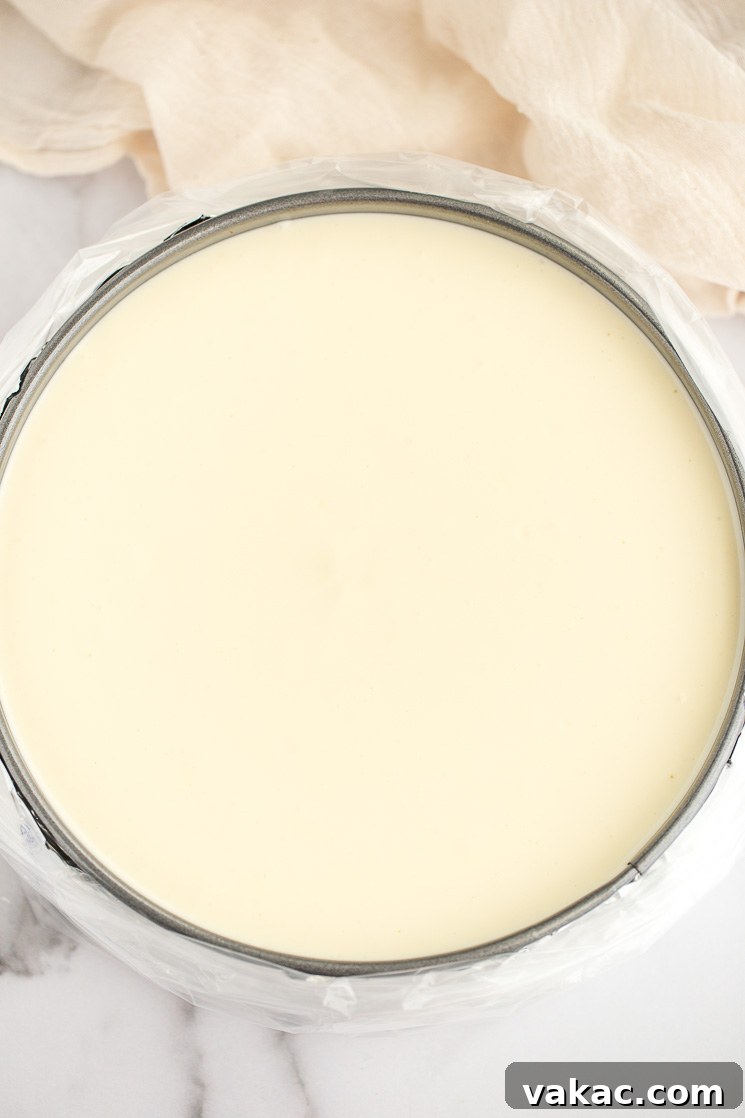 Grandma's Classic Cheesecake 5 A springform pan filled with filling and wrapped in an oven bag.